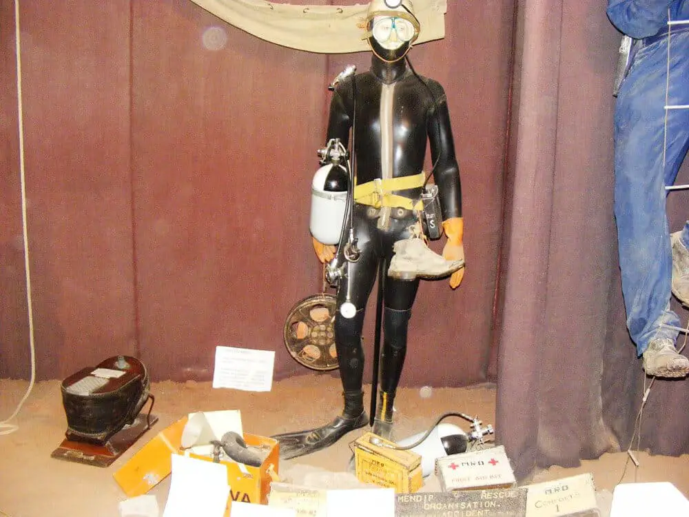 Photo of full cave diving gear: wet suit, goggles, helmet, gloves, and more