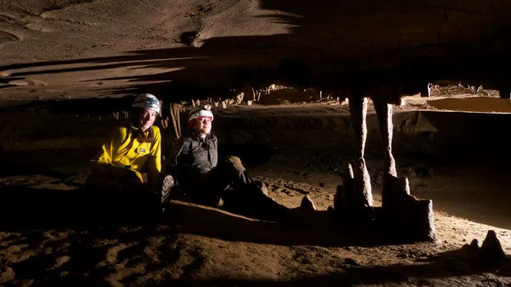 Picture of two geology students resting in a cave