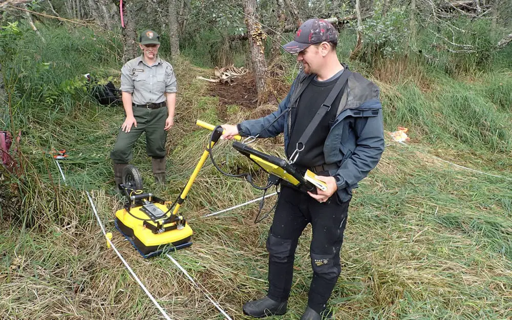 Photo of two men using ground pentetrating radar (GPR)