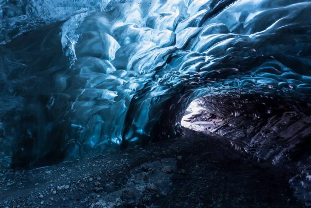 Glacier Ice Cave with blue glow and wavy walls