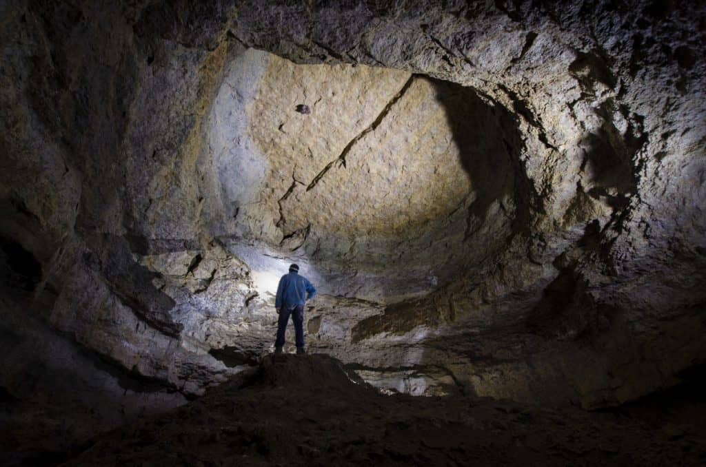 Man standing in a huge cave